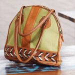 Colorblock fabric and leather round duffle bag with lace-up detail, handcrafted Rajasthan, BU117
