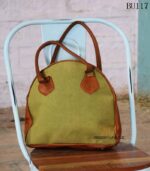 Colorblock fabric and leather round duffle bag with lace-up detail, handcrafted Rajasthan, BU117
