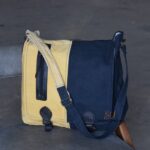 Mustard and navy two-tone canvas messenger bag, handcrafted in Rajasthan. Custom color combinations, private-label branding, worldwide export.