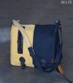 Mustard and navy two-tone canvas messenger bag, handcrafted in Rajasthan. Custom color combinations, private-label branding, worldwide export.