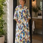 Woman wearing multicolor navy, mustard, and teal ikat print cotton kimono robe, handcrafted in Rajasthan BUW515