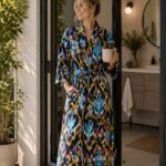 Woman wearing navy ikat print cotton kimono robe with mustard, teal, and pink diamond pattern, Rajasthan-made BUW517