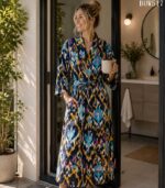 Woman wearing navy ikat print cotton kimono robe with mustard, teal, and pink diamond pattern, Rajasthan-made BUW517