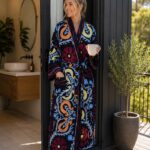 Woman wearing navy suzani floral and paisley print cotton robe with white piping, handcrafted in Rajasthan BUW519
