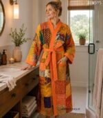 Woman wearing orange and gold patchwork kantha robe made from vintage sari fabric, Rajasthan-made loungewear BUW505