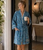 Woman wearing teal bandhani-style print cotton kimono robe with scalloped white trim, handcrafted in Rajasthan BUW514