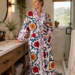 Woman wearing white cotton kimono robe with red, orange, and navy suzani floral print, Rajasthan handcrafted BUW508