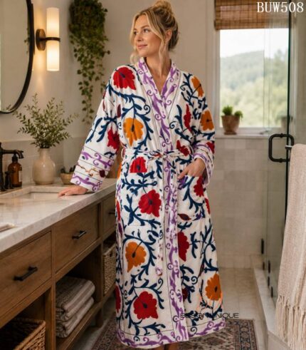 Woman wearing white cotton kimono robe with red, orange, and navy suzani floral print, Rajasthan handcrafted BUW508